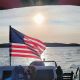 Lillipad American flag with a sunset a kid sleeping on a pontoon