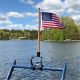 Flag On Teak Pole With Lake In Background